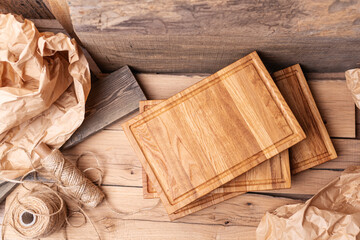 Composition of cutting boards. Oak planks. Free copy space. In the background wrapping paper, string and wooden boards. 