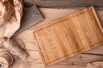Composition of cutting boards. Oak planks. Free copy space. In the background wrapping paper, string and wooden boards. 
