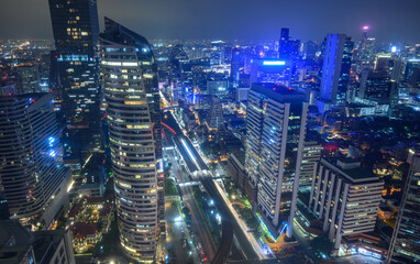 Aerial view of Bangkok city at night in Thailand. cityscape of Modern buildings, urban architecture and road traffic