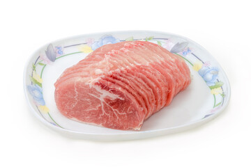 Sliced chilled raw pork loin on a dish