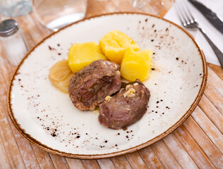 Baked pork pieces with potatoes in goulash closeup