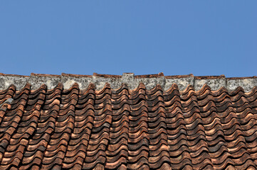 Traditional tile roof in a village in Indonesia with blue sky