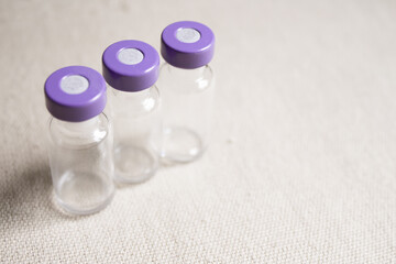 Empty glass jars of coronavirus vaccines