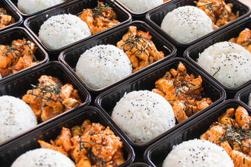 Korean food lunch boxes in plastic packages, Rice and spicy Korean pork stir-fry.