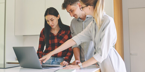 Successful woman architect presenting building project to the clients at laptop