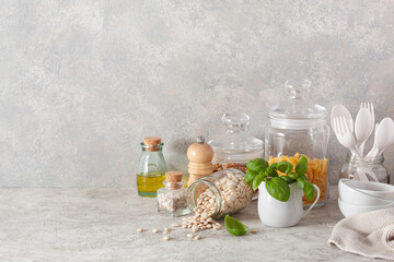 kitchen utensils on modern simple counter, kitchenware jars with dry ingredients bowls