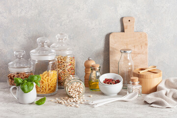 kitchen utensils on modern simple counter, kitchenware jars with dry ingredients bowls