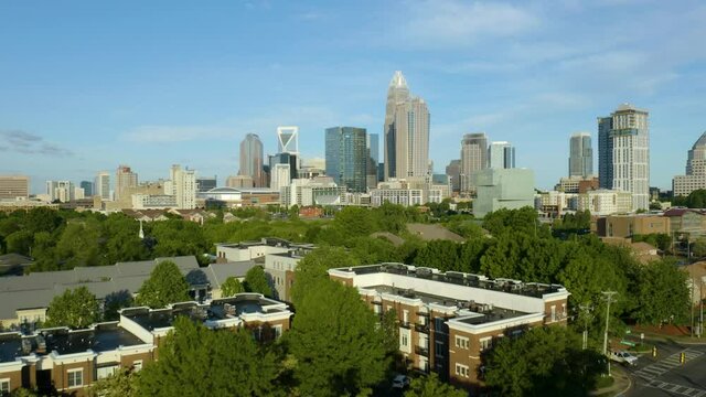 Downtown Charlotte, North Carolina Skyline Revealed Behind Trees. Dolly Rise Up