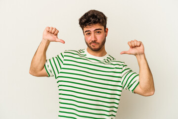 Young caucasian man isolated on white background feels proud and self confident, example to follow.