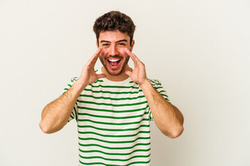 Young caucasian man isolated on white background shouting excited to front.