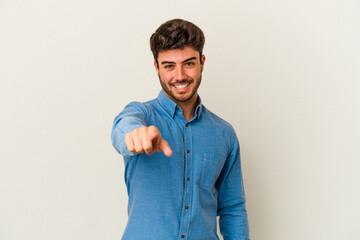 Fototapeta premium Young caucasian man isolated on white background pointing to front with fingers.