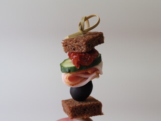 small sandwiches on toothpicks canapes in hand