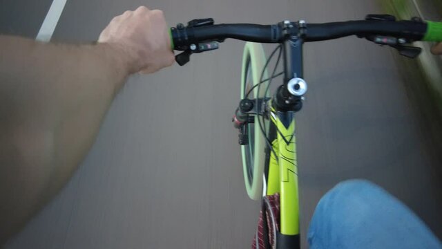 POV shot of a bicycle rider's hands on the grip of a handle bar