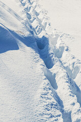 Human footprints in the deep snow.