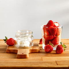 Fresh strawberries on a kitchen table in a bright summer afternoon kitchen 