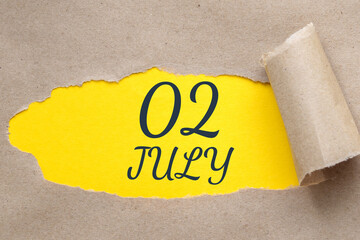 july 02. 02th day of the month, calendar date.Hole in paper with edges torn off. Yellow background is visible through ragged hole.Summer month, day of the year concept