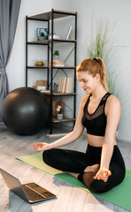 Home yoga. Wellness online. Mind body balance. Relaxed woman watching training therapy session on...