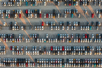 Aerial top down view of brand new cars at the logistics center, near the factory. Ready to export or import. Car parking lot.