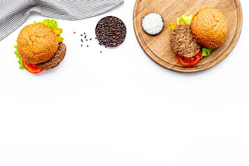 Homemade burgers on serving board. Fastfood meal background