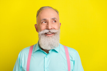 Photo of cunning beard aged man look empty space wear blue shirt isolated on vivid yellow color background