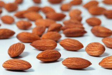 Background of almonds. Fried almonds. Scattered almond grains. Background for advertising