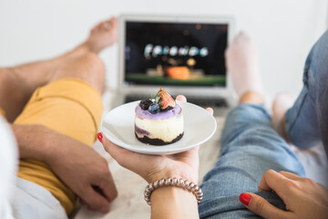 Portrait of her she his he nice attractive cheerful cheery glad friends friendship sitting on bed watching comedian show TV at modern industrial loft style brick interior living-room flat