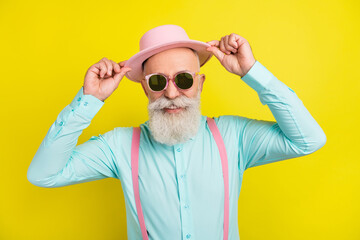 Photo portrait of old man wearing sunglass smiling cheerful in shirt suspenders isolated vibrant...