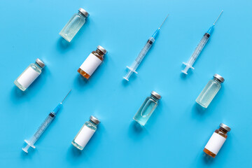Vaccination with Covid vaccine in bottles with syringe
