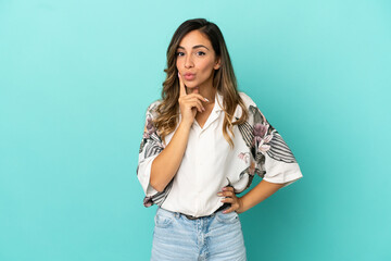 Young woman over isolated blue background and thinking