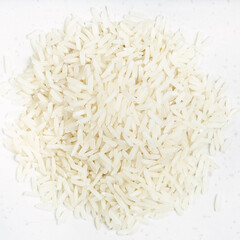 pile of polished long-grain rice close up on gray