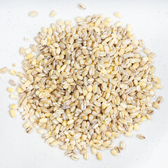 pile of pearled barley grains close up on gray