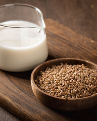 buckwheat and buckwheat milk on a wooden kitchen board, gluten-free.