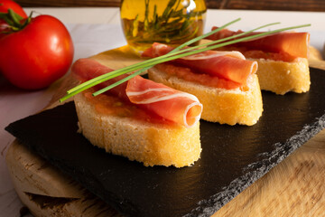 Spanish snack with bread, tomato ham and olive oil