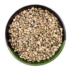 unpeeled hemp seeds in round bowl isolated