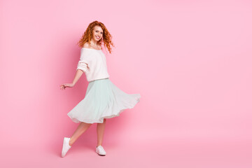 Photo portrait of young girl smiling spinning in skirt dancing on holidays isolated pastel pink...