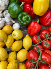 Lemons, peppers, tomatoes, garlic close-up on the table.