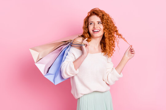 Photo of young girl happy positive smile shopaholic bags sale store discount look empty space isolated over pink color background