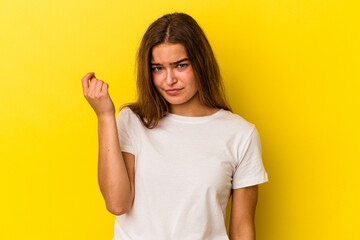 Young caucasian woman isolated on yellow background showing that she has no money.