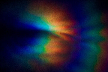 Blurred Bright multicolored glare on dark rough textured cardboard. Soft rainbow light. Abstract...