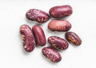 several red spotted pinto beans close up on gray