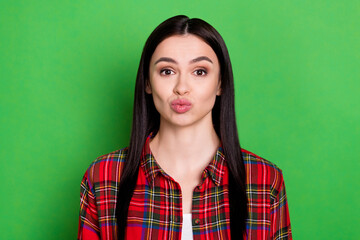 Photo of flirty straight hair young lady blow kiss wear red shirt isolated on green color background