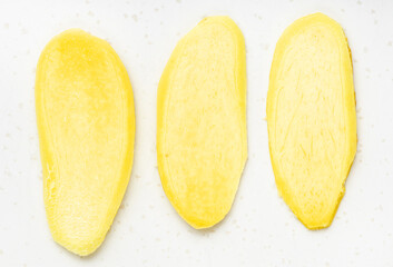 slices of fresh ginger root on gray plate