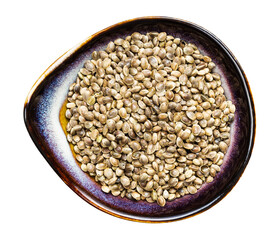top view of hemp seeds in ceramic bowl isolated