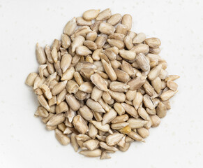 top view of pile of peeled sunflower seeds on gray