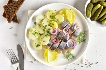 Sliced herring fish with boiled potatoes