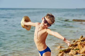 Portrait of a boy on the seashore . Children at the resort . © fisher05