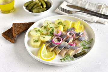 Sliced herring fish with boiled potatoes