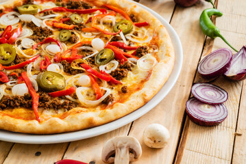 tasty pizza on the wooden background