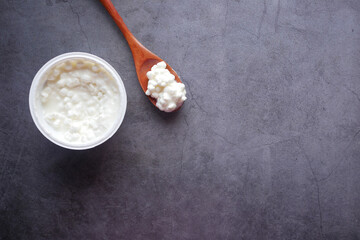 feta cheese in a container on black background 