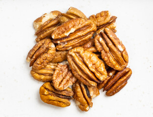 pile of shelled pecan nuts close up on gray